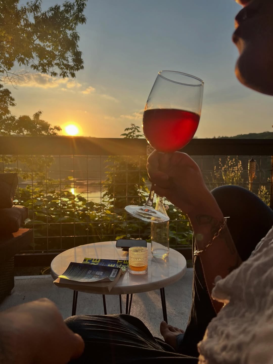 Sunset over the Delaware River with a glass of rosé at La Cigogne French Bistro Narrowsburg NY
