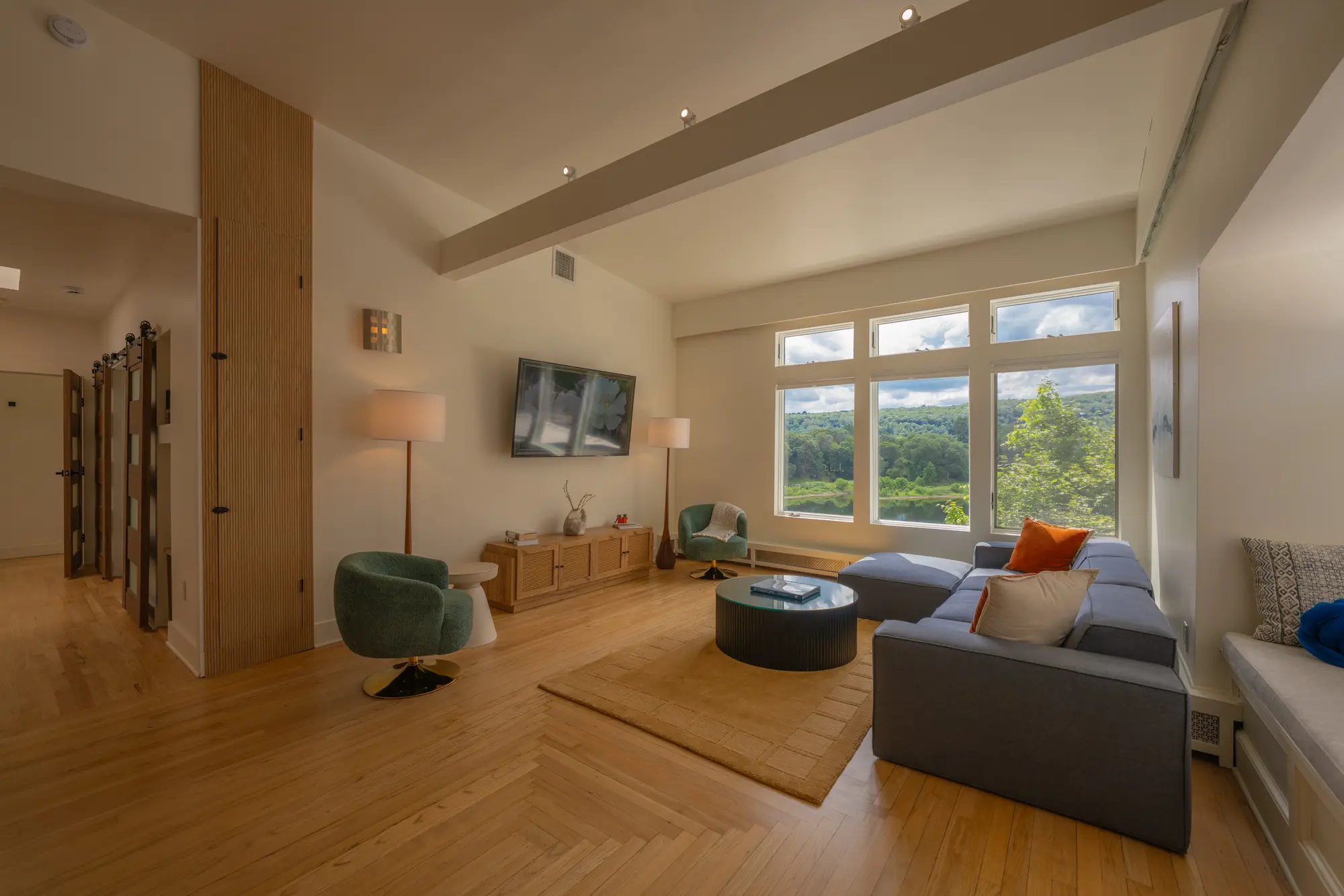 River Penthouse living room with Delaware River view, herringbone wood floors, vaulted ceiling, Narrowsburg NY